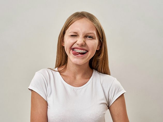 young girl with braces making a funny face 