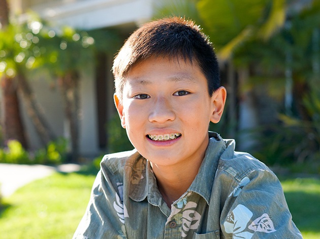 young boy smiling with braces 