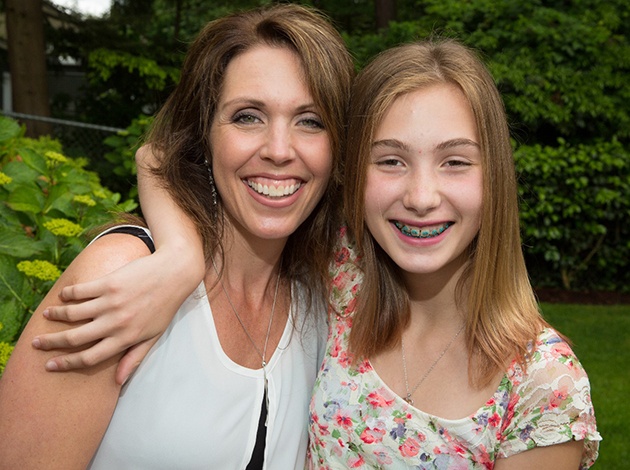 young girl with braces and her mom