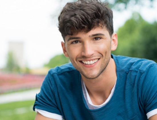 Smiling teenage boy in blue tee shirt