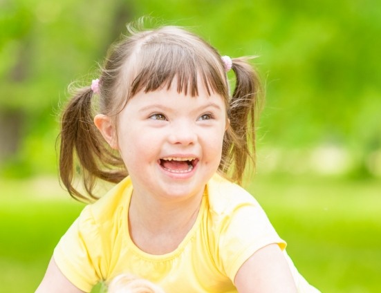 Girl with special needs smiling outdoors
