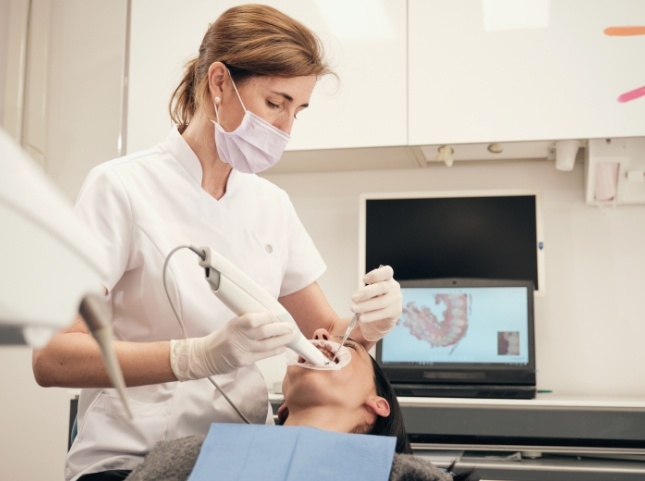 Dentist using a scanner on a patients teeth