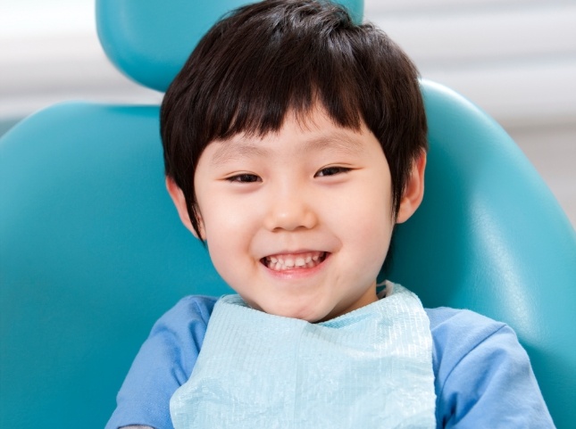 Young boy smiling in dental chair