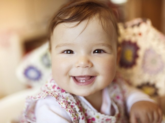 Smiling baby with only two lower teeth