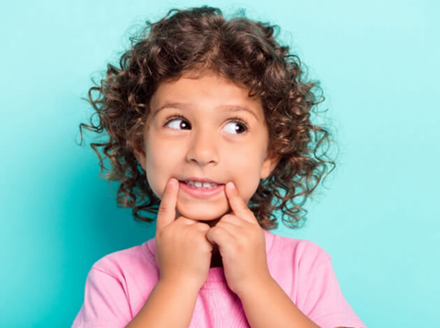 Toddler pointing to their mouth 