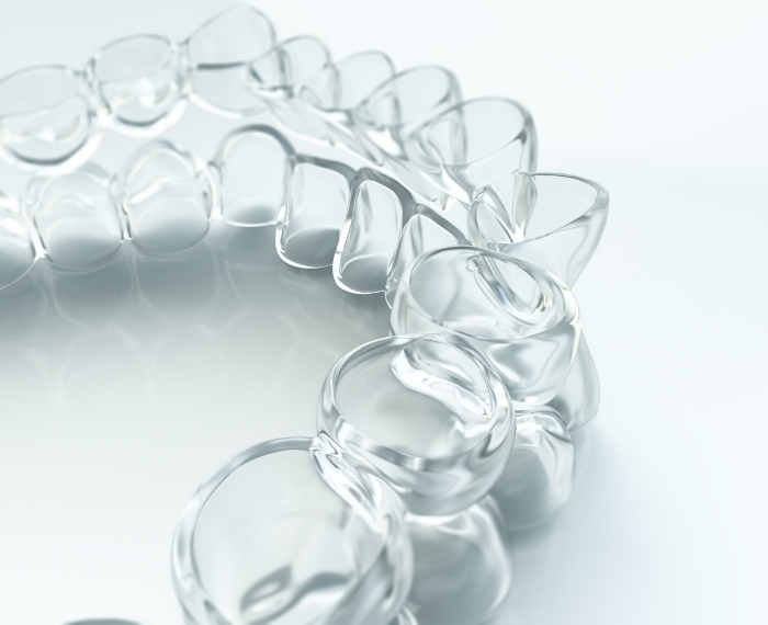 Close up of Invisalign tray on white surface